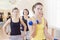 Female Fitness Teamwork Concepts. Closeup of Group of Four Caucasian Female Athletes Exercising with Barbells