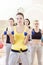 Female Fitness Teamwork Concepts. Group of Four Athletes Exercising with Barbells Indoors