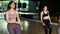 Female fitness women having a Latin dancing class together in gym studio. Group of young sportive women doing putting