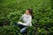 Female floriculturist checking potted hortensia