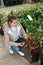 Female florist caring for potted kumquat