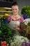 Female florist maintaining record on clipboard