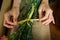 Female florist preparing bunch of flower in flower shop