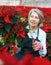 Female florist pruning poinsettia in greenhouse