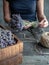 Female florist`s hands tied up bunch of lavender by twine. Working table