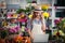 Female florist talking on mobile phone while using laptop