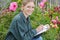 female florist writing on clipboard