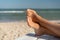 Female foot with hallux valgus close up on the beach