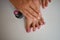 Female foot having a pedicure, putting pink nail polish on the nails of the feet and hands