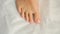 Female foot with pedicure, cosmetic treatment of feet and toenails