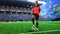 Female football player in red uniform on soccer field