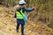 Female forestry inspector take pictures on smart phone near felling bushes