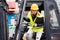 Female forklift truck driver outside a warehouse.