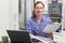 Female Freelance Worker Using Laptop In Kitchen At Home