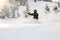 Female freeride snowboarder riding down the mountain snowcovered slope