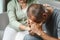 Female friend or family sitting and hold hands during cheer up to mental depress man, Psychologist provides mental aid to patient