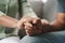 Female friend or family sitting and hold hands during cheer up to mental depress man, Psychologist provides mental aid to patient