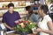 Female Friends Buying Potted Plant