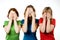 Female friends covering eyes