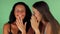 Female friends gossiping on green chromakey background