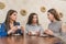 Female friends having a coffee together. Three women at cafe drinking, talking, laughing and enjoying their time