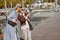 Female friends having conversation on promenade by sea