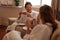 Female friends having herbal tea and chatting in spa