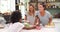 Female Friends Making Breakfast Whilst Checking Mobile Phone