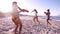 Female friends playing with water guns on the beach