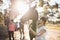 Female friends stroking horses at barn