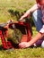 Female gardener with broken lawnmower