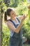 Female gardener examining leaves at garden