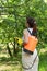 Female gardener with knapsack garden spray