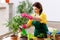 The female gardener with plants indoors