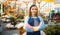 Female gardener poses in shop for gardening