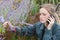 Female gardener receiving negative news on telephone
