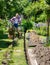 Female gardener resting after digging trench for underground drip irrigation in yard