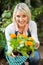 Female gardener showing potted flowering plant