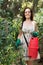 Female gardener spraying tomato plant