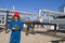 Female gas field operator inspects compressor site