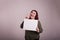 Female gesturing peace sign with hand holding a blank whiteboard