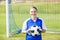 Female goalkeeper standing with ball