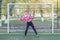 Female goalkeeper stands at the goal