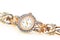 Female golden wrist watch with diamonds close up