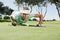 Female golfer blowing her ball on putting green