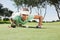 Female golfer blowing her ball on putting green