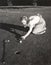 Female golfer crouching to line up a shot