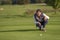 Female golfer lining up a putt