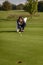 Female golfer lining up a putt