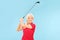 Female golfer swinging a golf club